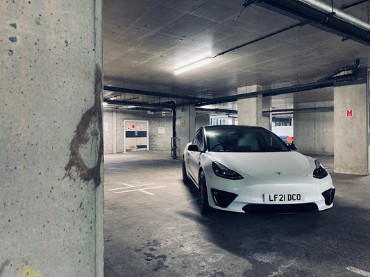 a white car parked in a parking garage