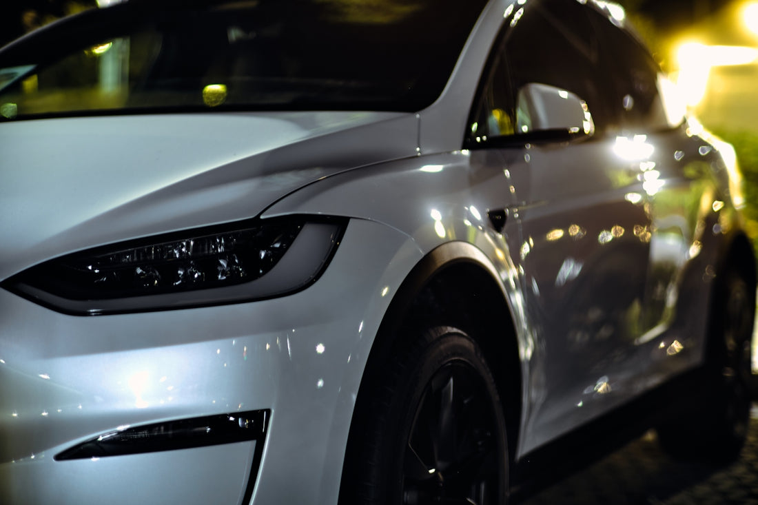 a white car parked on a street at night