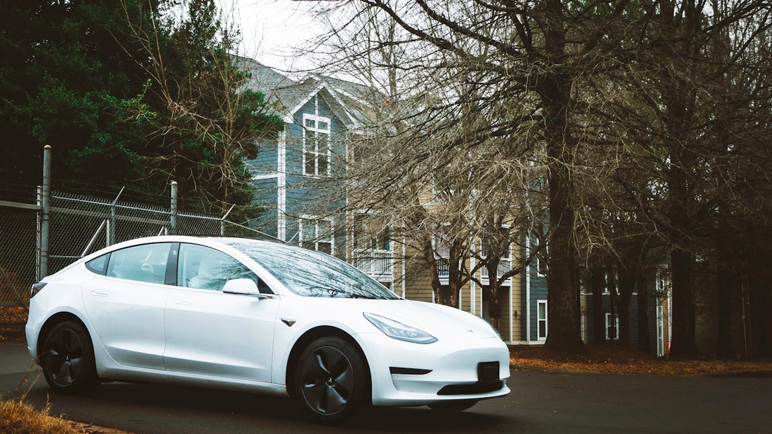 a white car parked in front of a house