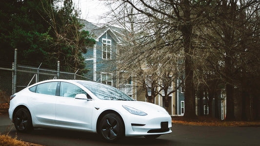 a white car parked in front of a house
