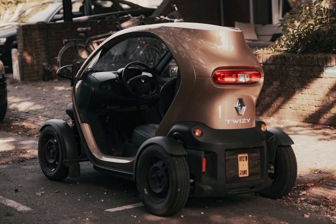 A small car is parked on the side of the road